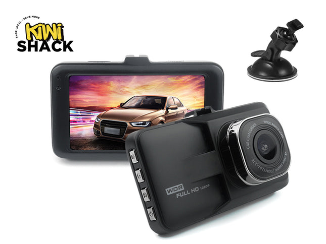 Car dashboard camera with screen displaying a car on a road, suction cup mount, and Kiwi Shack logo.