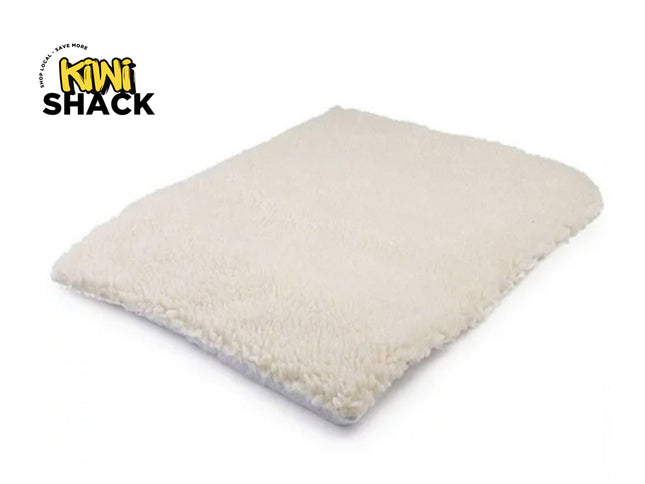 Beige pillow with a visible 'Kiwi Shack' logo on a white background