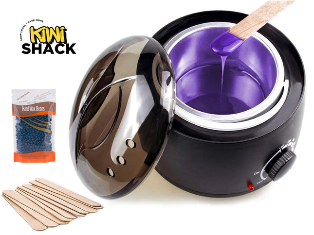 Black waxMelter with purple wax, wooden sticks, and Kiwi Shack packaging on a white background