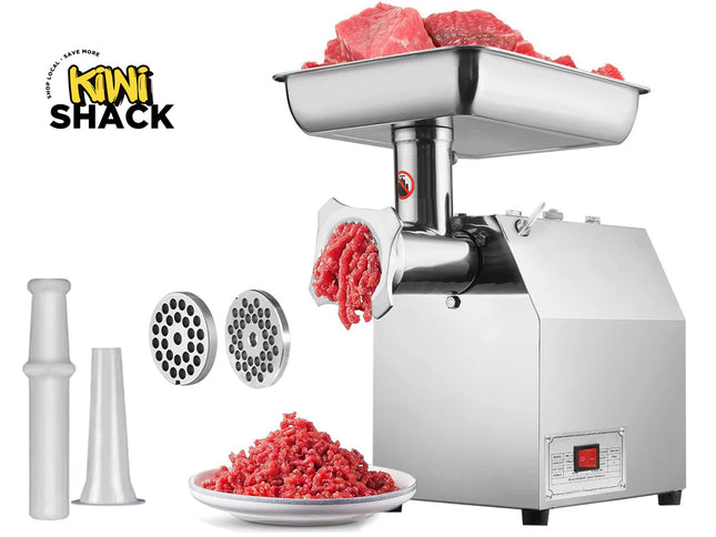 Stainless steel meat grinder with ground meat output, attachments, and raw meat input on a white background.