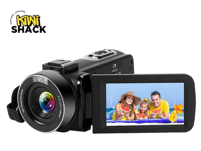 Black digital camera with a screen displaying a family at the beach, branded 'Kiwi Shack'.