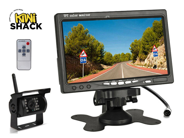 Car monitor with remote control and camera, branded as Kiwi Shack, displaying a road scene.