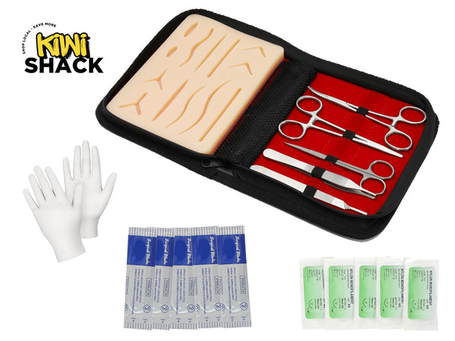 Medical training kit with a brain model, scissors, gloves, and bandages on a white background.