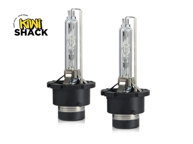 Two car headlights with black casings on a white background, branded 'Kiwi Shack'.