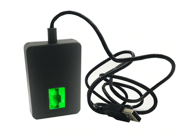 Black electronic device with a green display and USB cable on a white background