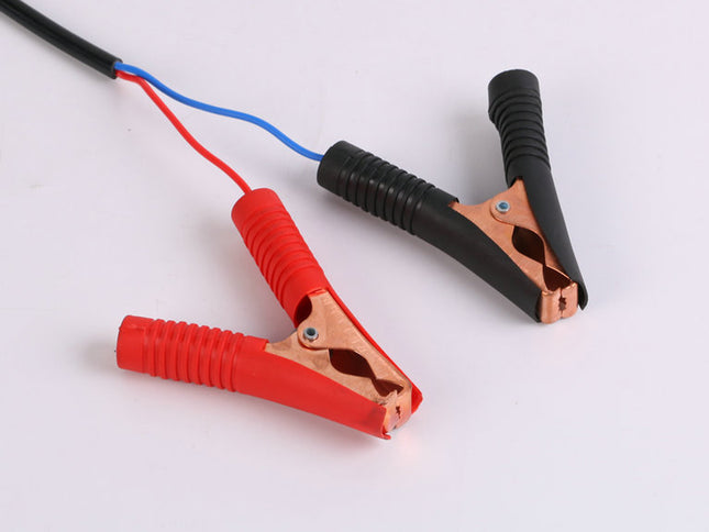 Red and black alligator clips with wires on a white background
