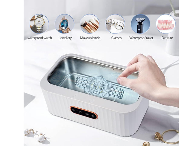 Hand using a small rectangular cleaning device with various items above it on a white background