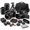 An assortment of photography and videography equipment, including a mirrorless camera, a camcorder, camera lenses, a tripod, a carrying case, spare batteries, memory cards, and cleaning accessories on a white background.