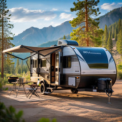 RV parked in a forest with mountains in the background