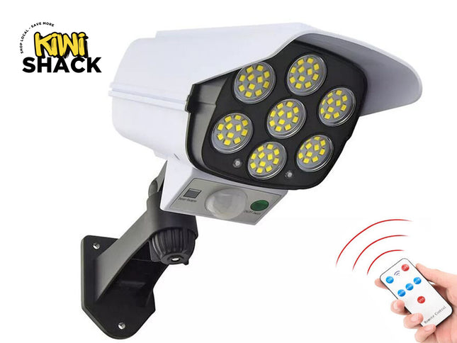 Security camera with LED lights and a remote control, branded as Kiwi Shack.