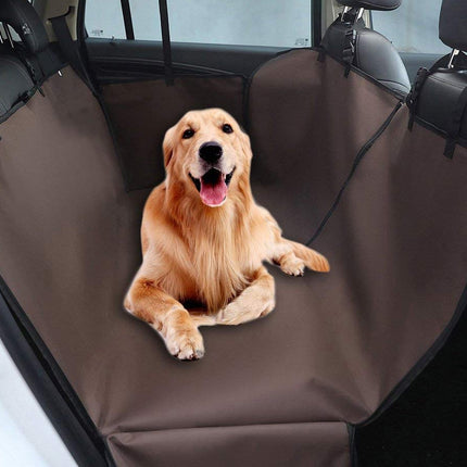 Dog sitting on a brown car bench cover in a vehicle
