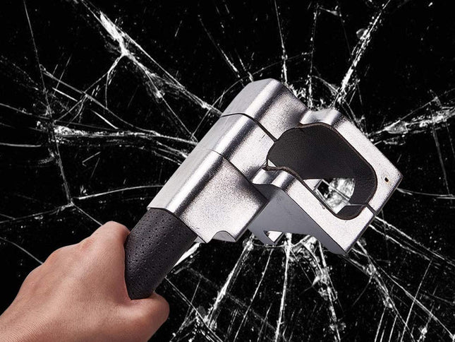 A hand holding a silver and black glass breaker tool, shown striking against a black background with shattered glass cracks radiating outward.