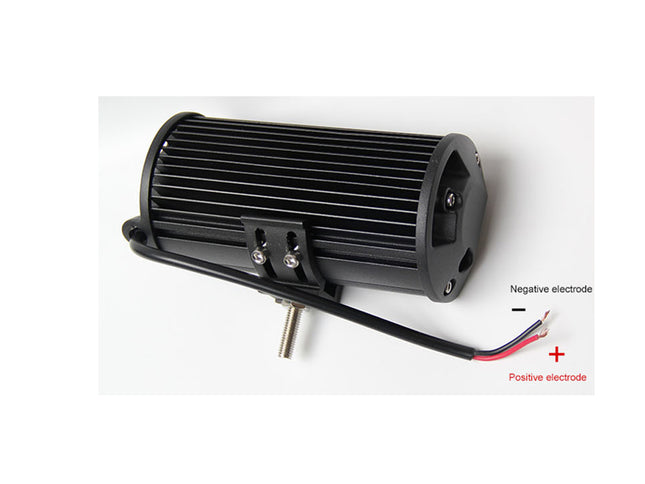 Black electrical component with labeled positive and negative electrodes on a white background