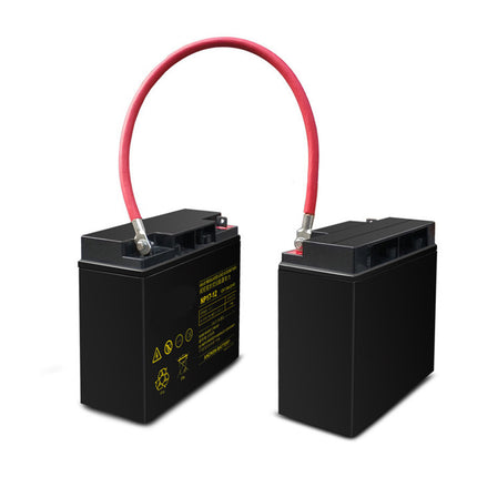 Two black batteries with red and black cables on a white background