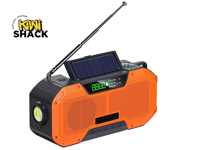Orange and black portable radio with solar panel and compass, branded 'Kiwi Shack'.