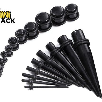 Set of black ear stretching plugs and tapers in graduated sizes, arranged in a curved line of plugs at the top-left and a fan of tapering stretchers with O-rings at the bottom-right. Kiwi Shack logo in top-left corner.