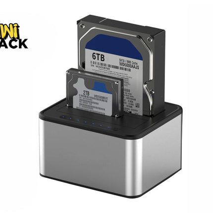 A silver and black dual-bay hard drive docking station holding a larger 3.5-inch desktop hard drive and a smaller 2.5-inch laptop hard drive with blue status indicator lights, featuring a "Kiwi Shack" logo in the top left corner.