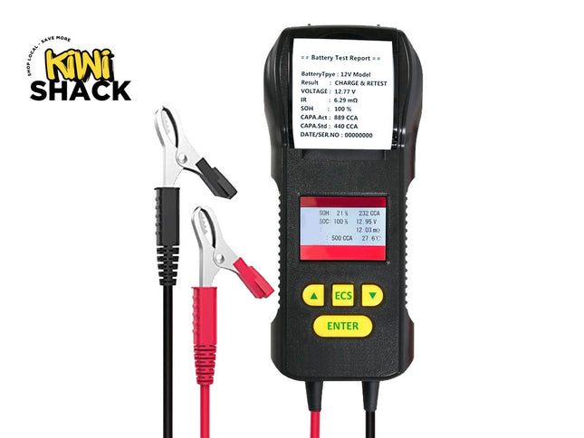 Battery tester with clamps and display screen on a white background, branded 'Kini Shack'.