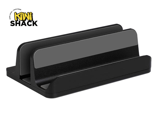 A black dual vertical laptop stand with protective grey silicone padding inside the slots, featuring a "Kiwi Shack" logo in the top left corner.