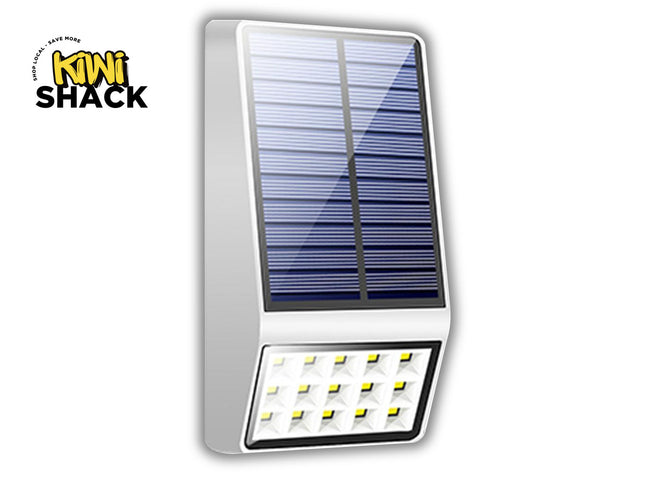 A solar-powered outdoor wall light by Kiwi Shack, featuring a rectangular blue solar panel on a white housing with multiple LED light elements at the bottom, shown on a white background with a Kiwi Shack logo in the top-left corner.