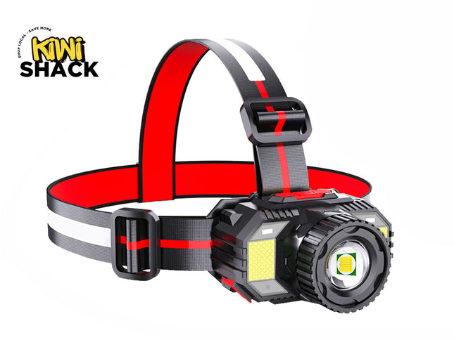 A black and red LED headlamp featuring an adjustable strap, a prominent central spotlight, and side floodlight panels, set against a plain white background with a "Kiwi Shack" logo in the top left corner.