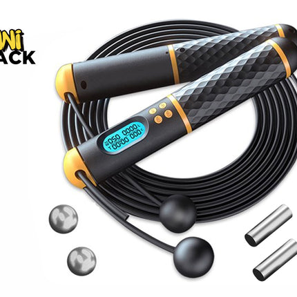 A black and yellow digital jump rope with textured handles, an integrated LCD screen showing workout data, a coiled black skipping rope, two optional short cordless weighted balls, and two metal weight inserts, set against a plain background with the "Kiwi Shack" logo in the top left corner.