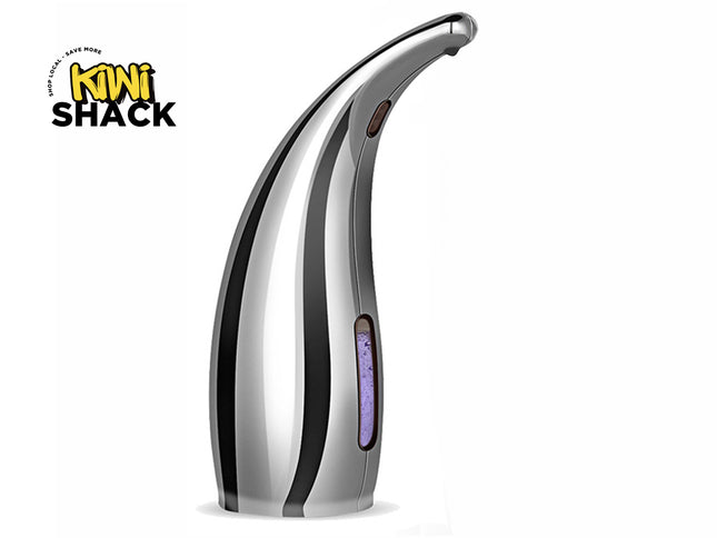 A polished silver automatic touchless soap dispenser with a curved nozzle and a vertical liquid level window showing purple soap inside, set against a white background. A "Kiwi Shack" logo appears in the top-left corner.