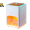 A Kiwi Shack portable humidifier and diffuser with a white body, a wood-grain top panel, and an illuminated orange salt crystal chamber, shown on a white background with the Kiwi Shack logo in the top-left corner.
