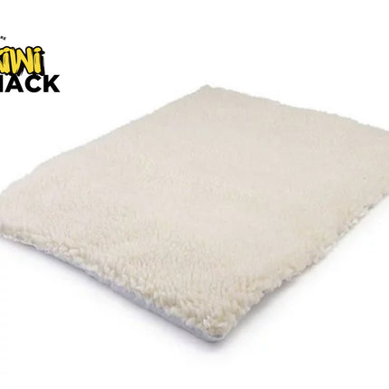 Beige pillow with a visible 'Kiwi Shack' logo on a white background