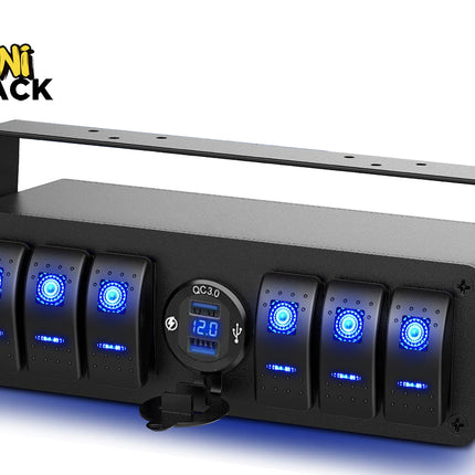 A black multi-gang rocker switch panel with blue backlit LED switches, a central QC 3.0 dual USB charger socket with a digital voltmeter display, and an overhead mounting bracket, featuring a "Kiwi Shack" logo in the top left corner.