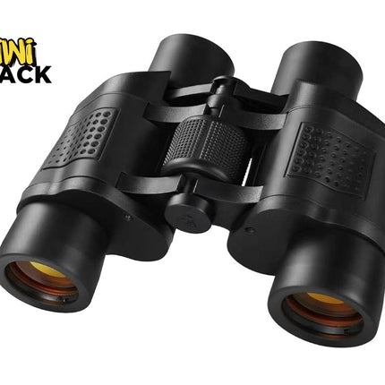 A pair of black binoculars with coated amber lenses and a central focus wheel, featuring the "Kiwi Shack" logo in the top-left corner.