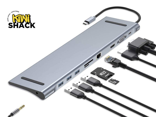 A silver aluminum multi-port USB hub with attached black cables, shown on a white background with the Kiwi Shack logo in the top-left corner. The hub includes USB-A, USB-C, Ethernet, HDMI, and DisplayPort ports, along with a 3.