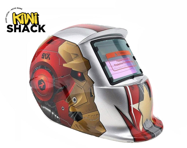 An auto-darkening welding helmet featuring a silver, red, and gold comic-book-inspired robotic armor graphic design, an auto-darkening viewing window, and mechanical details against a white background, with the "Kiwi Shack" logo in the upper left corner.