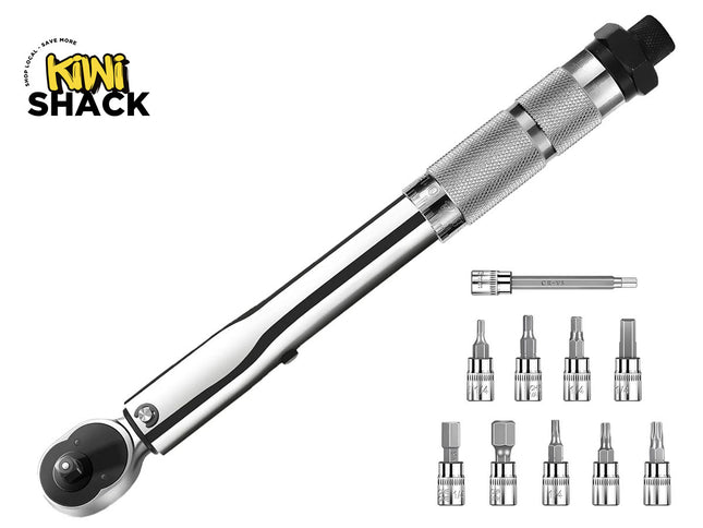 A chrome click torque wrench with a knurled adjustable handle and a ratchet head, accompanied by an extension bar and a set of assorted bit sockets displayed on the right, featuring a "Kiwi Shack" logo in the top left corner.