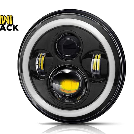 Car headlight with black casing and white rim, featuring Kiwi Shack logo.