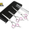 A set of stainless steel pet grooming scissors, thinning shears, and a metal comb with pink finger rings, arranged next to a black zipper case, featuring the "Kiwi Shack" logo in the top-left corner.
