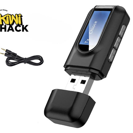 A black USB Bluetooth audio transmitter device with an LCD screen, control buttons along the side, an uncapped USB connector, and an accompanying 3.5mm auxiliary audio cable against a white background, featuring the "Kiwi Shack" logo in the upper left corner.