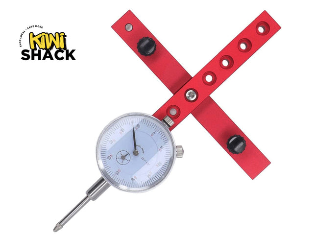 A red metal dial indicator with a silver gauge face and probe, shown on a white background with the Kiki Shack logo in the top-left corner.