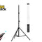 A black tripod light stand with a tall cylindrical lamp attached, shown on a white background. A hand holding a black remote control appears in the lower left, and the Kiwi Shack logo is in the upper left.