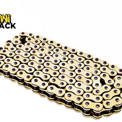Coiled gold-tone heavy-duty drive chain / motorcycle chain with dark pins/rivets, neatly folded/layered flat, and the Kiwi Shack logo watermark.