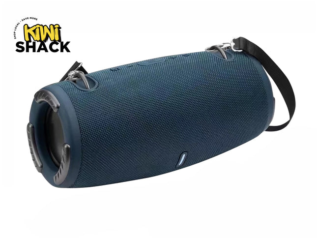 Dark blue cylindrical portable Bluetooth speaker wrapped in mesh fabric, featuring dual exposed end-cap passive bass radiators, top control buttons, strap anchor loops with a black carrying strap attached, a front power/status indicator light, and the Kiwi Shack logo watermark.