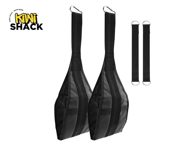 Pair of black padded ab/leg raise hanging slings with upper metal snap hooks, two separate vertical hanging straps with D-rings on the right, and Kiwi Shack logo in top left.