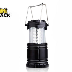 A black collapsible LED camping lantern featuring a clear plastic light column with internal LED strips and dual metal wire handle loops against a white background, featuring the "Kiwi Shack" logo in the upper left corner.