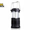 A black collapsible LED camping lantern featuring a clear plastic light column with internal LED strips and dual metal wire handle loops against a white background, featuring the "Kiwi Shack" logo in the upper left corner.