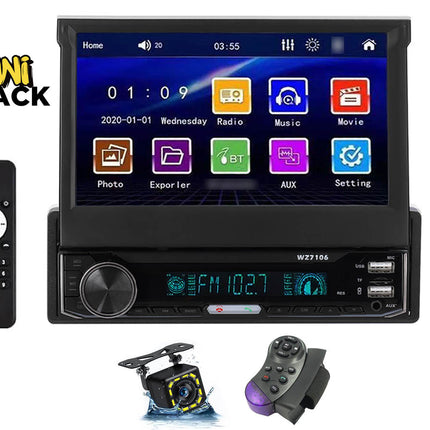 Single-DIN car stereo with motorized retractable touch screen showing main menu interface, FM radio lower receiver unit with volume knob and dual USB ports, remote control on the left, backup camera and steering wheel remote at the bottom, and Kiwi Shack logo in top left.