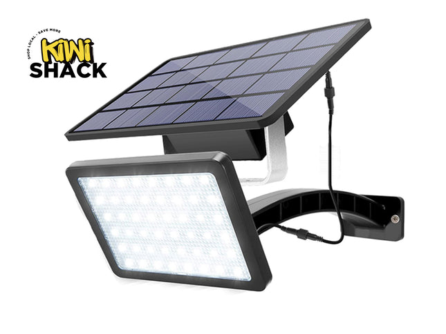 Solar flood light with solar panel on a white background, featuring the Kiwi Shack brand.