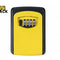 A yellow and black wall-mounted key lock box with a 4-digit combination dial, featuring the "Kiwi Shack" logo in the top-left corner.