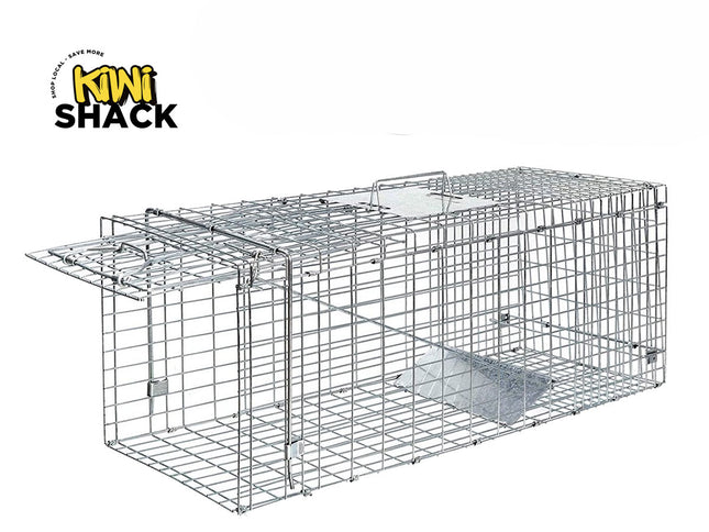 A galvanized wire mesh live animal humane trap with a spring-loaded door mechanism, featuring the "Kiwi Shack" logo in the top-left corner.