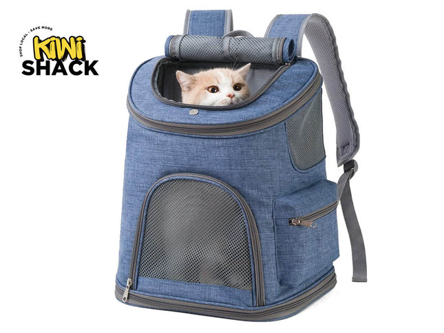 Blue heather-fabric pet carrier backpack featuring an arched mesh lower front ventilation window, zippered side/front pockets, a padded roll-up top mesh window with a calico / light orange and white cat looking out of the top opening, padded shoulder straps, and the Kiwi Shack logo watermark.