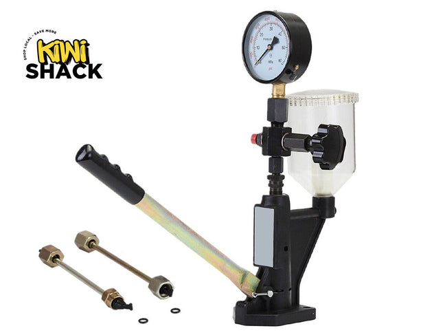 Manual diesel fuel injector nozzle / pressure tester pop tester unit featuring a black and metallic pump handle with a black rubberized grip, top-mounted circular pressure gauge, clear transparent fluid reservoir cup with screw-on lid, adjustment valve knob, mounted base pedestal, two associated high-pressure metal connector lines with flare fittings, small O-rings lying below, and the Kiwi Shack logo watermark.